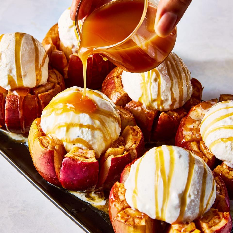 apples cut and topped with vanilla ice cream and caramel