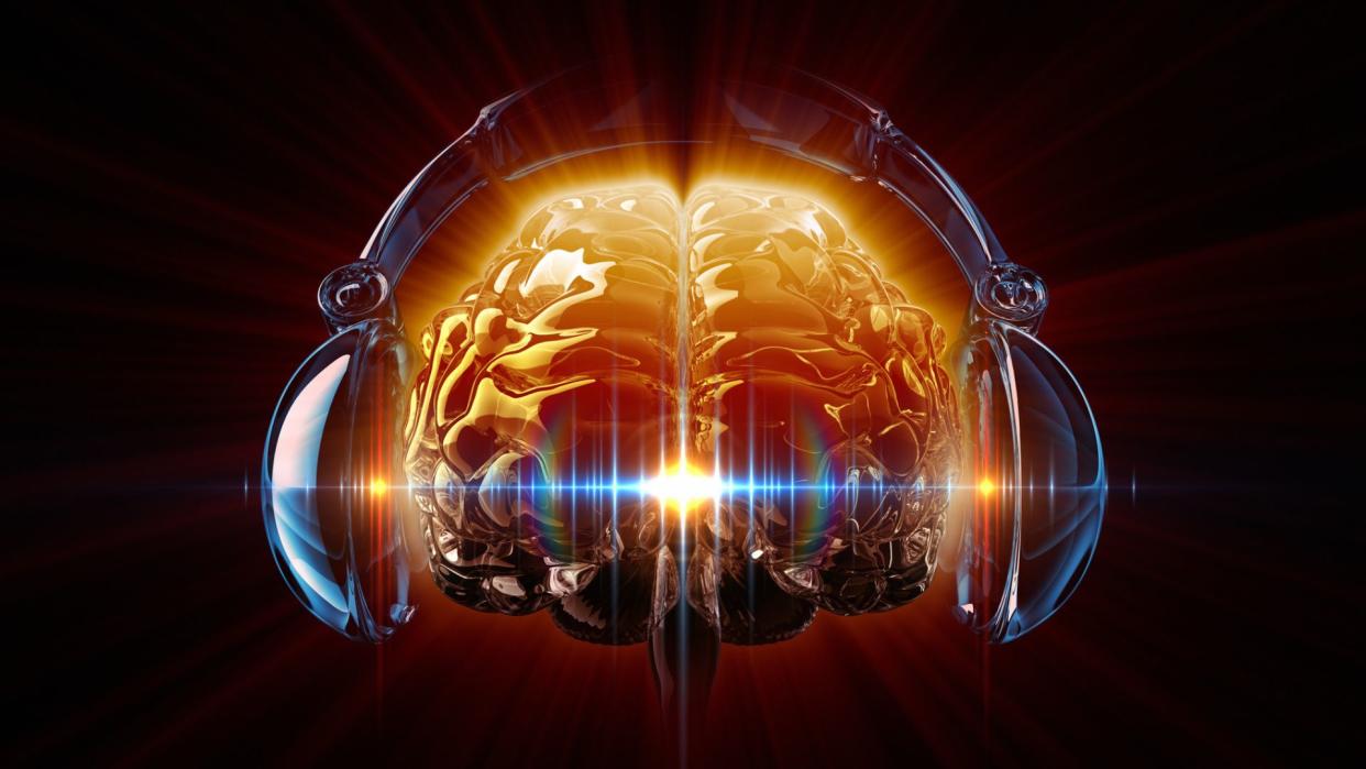  illustration of a brain wearing over-ear headphones, with a musical waveform shown rippling through it 