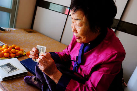 Lee Yong-soo, 90, one of less than 30 known surviving South Korean victims of JapanÕs wartime brothels, displays a photograph in Daegu, South Korea October 30, 2018, of her taken shortly after she returned to Korea in 1945 after being held at an airbase for kamikaze pilots in Taiwan. REUTERS/ Josh Smith