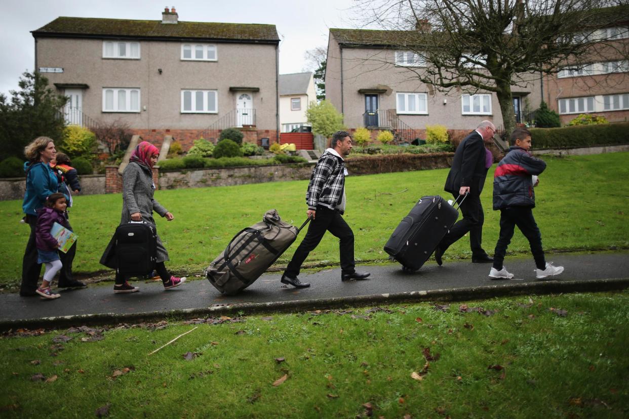 Syrian refugees arrive at their new home in Scotland in 2015: Getty