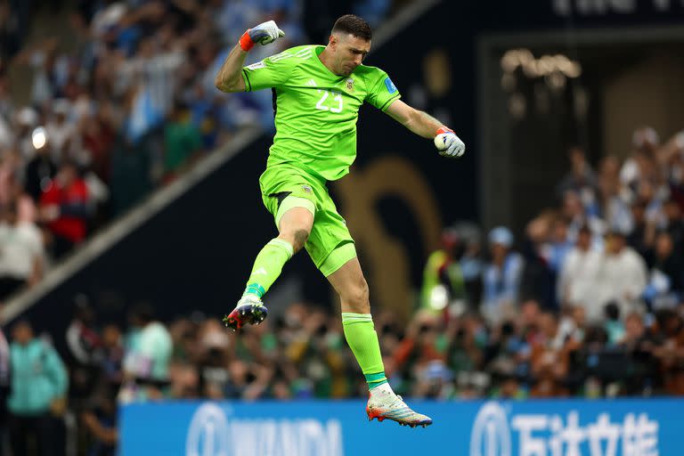 LUSAIL CITY, QATAR - DECEMBER 18: Emiliano Martinez of Argentina celebrates after saving the second penalty from Kingsley Coman of France in the penalty shoot out  during the FIFA World Cup Qatar 2022 Final match between Argentina and France at Lusail Stadium on December 18, 2022 in Lusail City, Qatar. (Photo by Lars Baron/Getty Images)