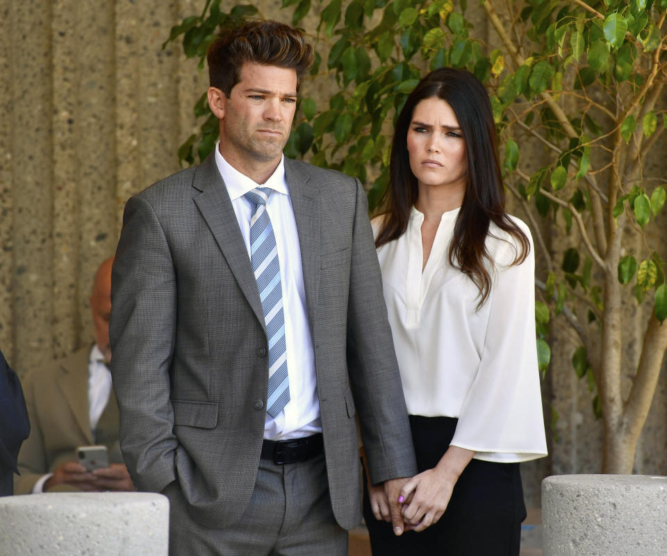 FILE - In this Oct. 17, 2018, file photo, Dr. Grant Robicheaux and his girlfriend Cerissa Riley listen during a news conference by their lawyer Philip Kent Cohen in Newport Beach, Calif. State prosecutors want to drop most sex crime charges filed against a reality TV doctor and his girlfriend, who are accused of drugging and raping several women at their Southern California home. The attorney general's office, which took over the case last year, asked an Orange County judge on Friday, May 14, 2021, to drop charges involving six of seven alleged victims. (Paul Bersebach/The Orange County Register via AP, File)