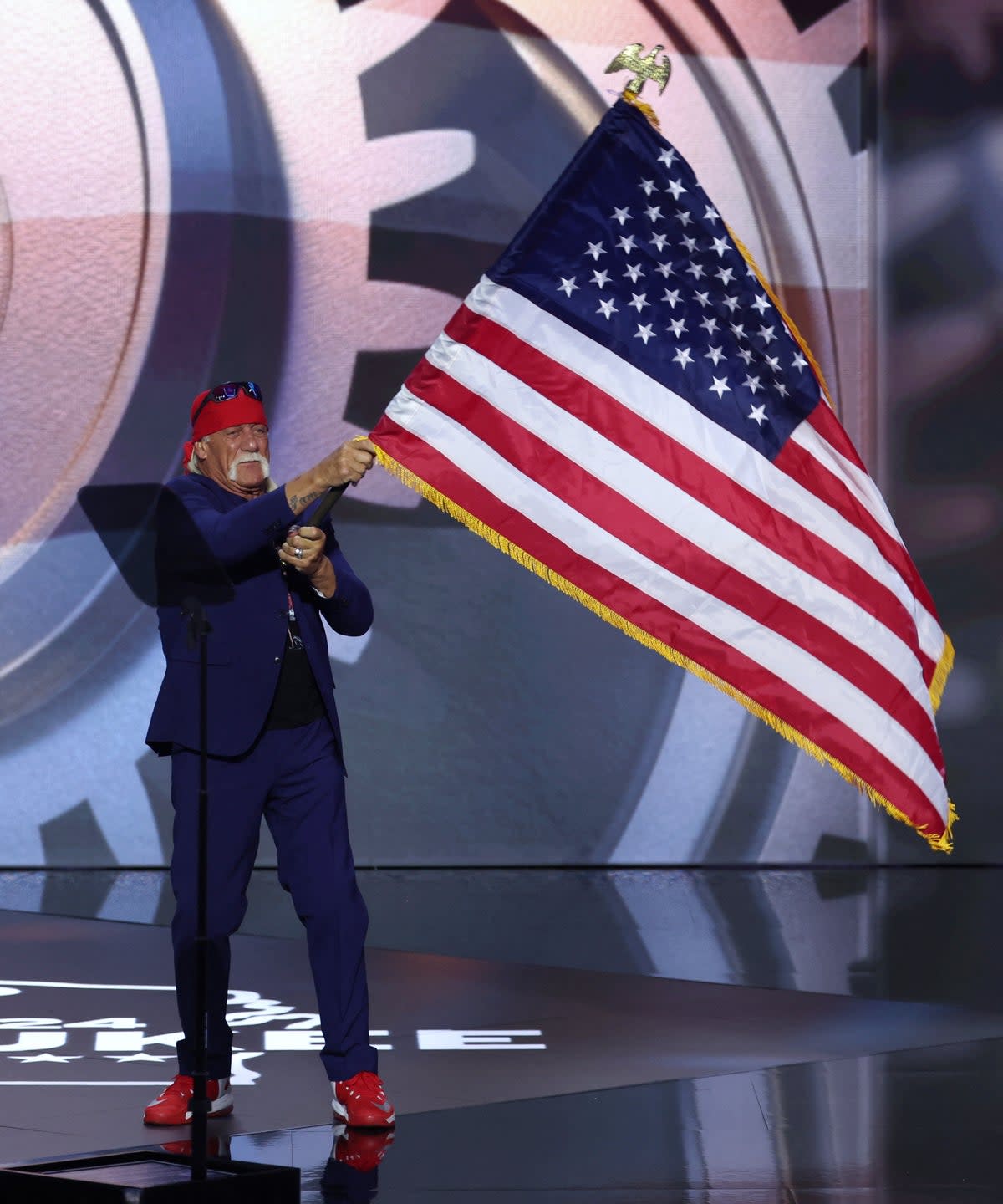 Hogan bounded onto the stage to his former wrestling theme tune ‘Real American’ and waving an enormous US flag (REUTERS)