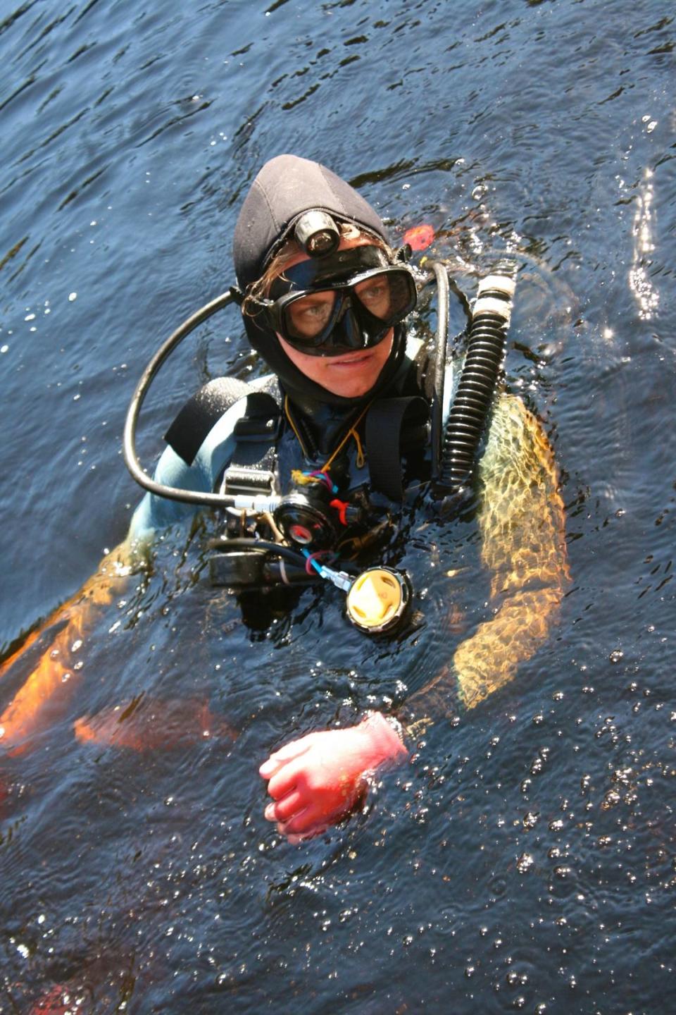 Jessi Halligan, an associate professor of anthropology at Florida State University, prepares to dive in the Aucilla River in search of artifacts from the first people who occupied Florida.
