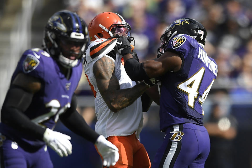 FILE - In this Sunday, Sept. 29, 2019, file photo, Cleveland Browns wide receiver Odell Beckham, center, and Baltimore Ravens cornerback Marlon Humphrey (44) grab each other during the second half of an NFL football game in Baltimore. Browns coach Freddie Kitchens wants more consistent NFL officiating after wide receiver Odell Beckham Jr. was choked during Sunday’s game. Beckham got into a skirmish with Ravens cornerback Marlon Humphrey, who pinned the three-time Pro Bowler and had his hands around his neck before being pulled away. Both players were assessed personal fouls, but neither was ejected. Kitchens said he planned to reach out to the league about that situation in particular and officiating evenness in general. (AP Photo/Nick Wass, File)