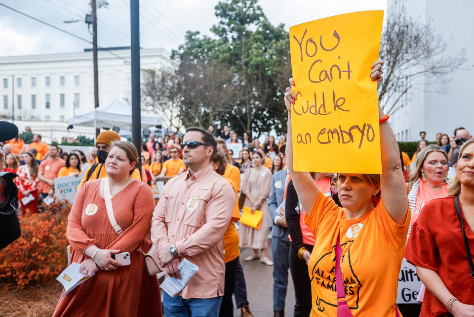 Carrie McNair holds a sign for IVF rights (Stew Milne / AP for The National Infertility Association)