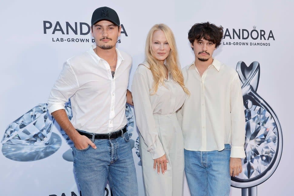 Pamela Anderson with sons Brandon Lee and Dylan Lee at a Pandora event during NYFW on Sept. 6, 2023.
