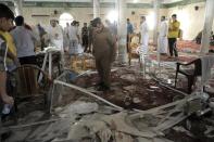 Saudi police inspect the debris following a blast inside a mosque in the coastal town of Qatif, on May 22, 2015