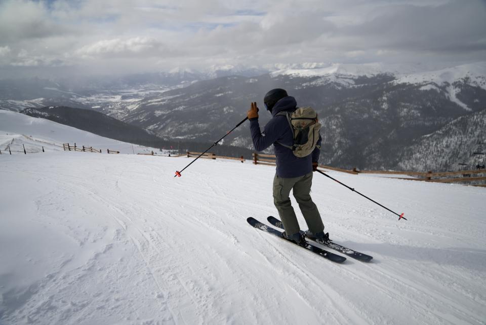 A skier goes down a hill at Arapahoe Basin Ski Area on Friday, Jan. 20, 2023, in Dillon, Colo. As global warming threatens to put much of the ski industry out of business over the next several decades, resorts are beginning to embrace a role as climate activists. (AP Photo/Brittany Peterson)