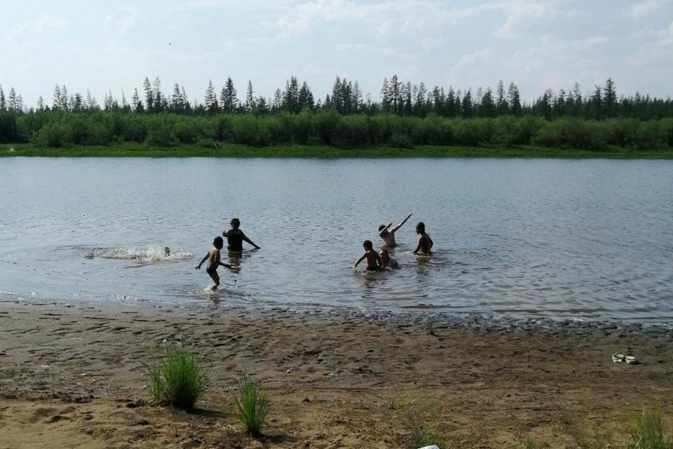 Children play in the Krugloe Lake outside Verkhoyansk, Sakha Republic, about 2,900 miles northeast of Moscow. Russia's meteorological service said the thermometer hit 100.4 degrees June 20 in Verkhoyansk.