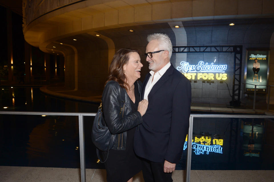 Amy and Bradley smiling, standing in front of a movie premiere