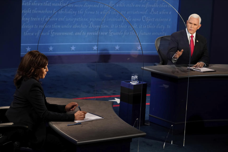 Vice President Mike Pence looks at Democratic vice presidential candidate Sen. Kamala Harris, D-Calif., as he answers a question during the vice presidential debate Wednesday, Oct. 7, 2020, at Kingsbury Hall on the campus of the University of Utah in Salt Lake City. (AP Photo/Morry Gash, Pool)