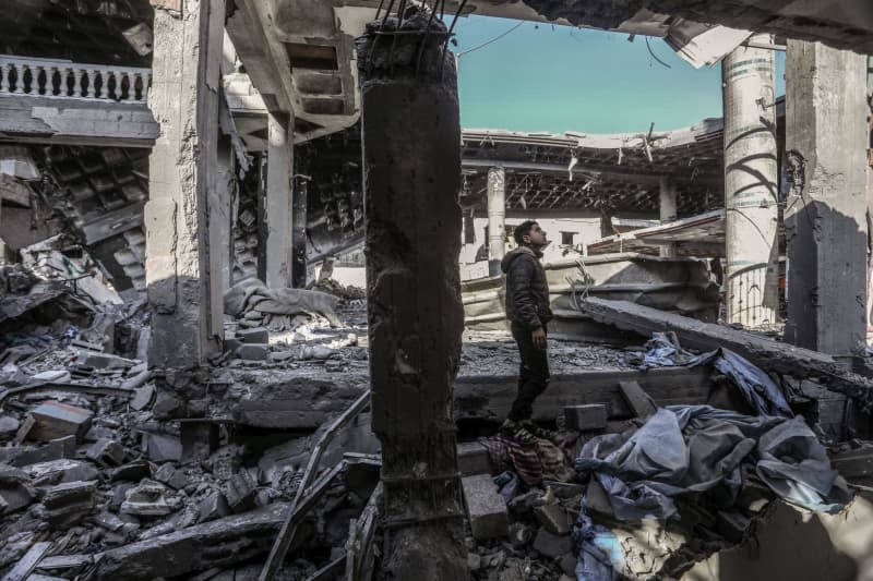 A Palestinian inspects a house belonging to the Abu Al-Hinud family, after an Israeli air strike, which resulted in eight deaths and a number of injuries. Abed Rahim Khatib/dpa