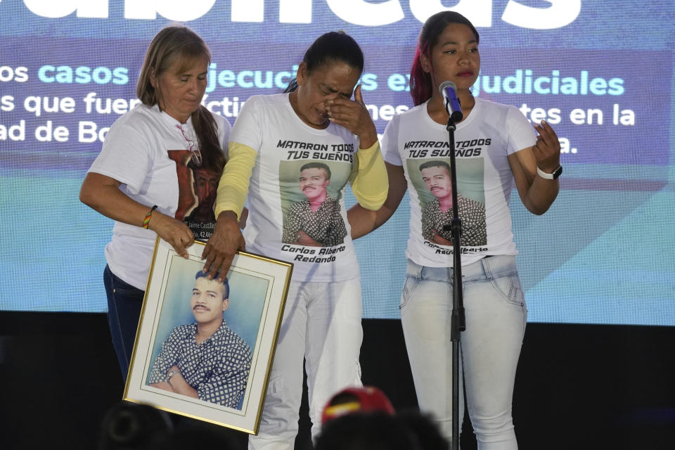 Maria Perez, center, mother of Carlos Redondo, one of the 19 young people who were falsely presented as guerrillas killed in combat by the Colombian army during the country's internal conflict, cries during an act of recognition and public apology by the state for their extrajudicial execution, in Bogota, Colombia, Tuesday, Oct. 3, 2023. (AP Photo/Fernando Vergara)