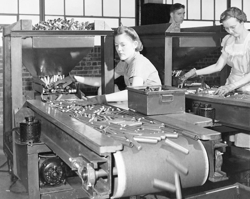 FILE - In this June 26, 1942, file photo, women workers at the St. Louis Ordnance plant inspect 50 calibre shell casings. This is the first inspection of the shells after they come through the metal shaping machines. Not since World War II when factories converted from making automobiles to making tanks, Jeeps and torpedos has the entire nation been asked to truly sacrifice for a greater good. (AP Photo, File)