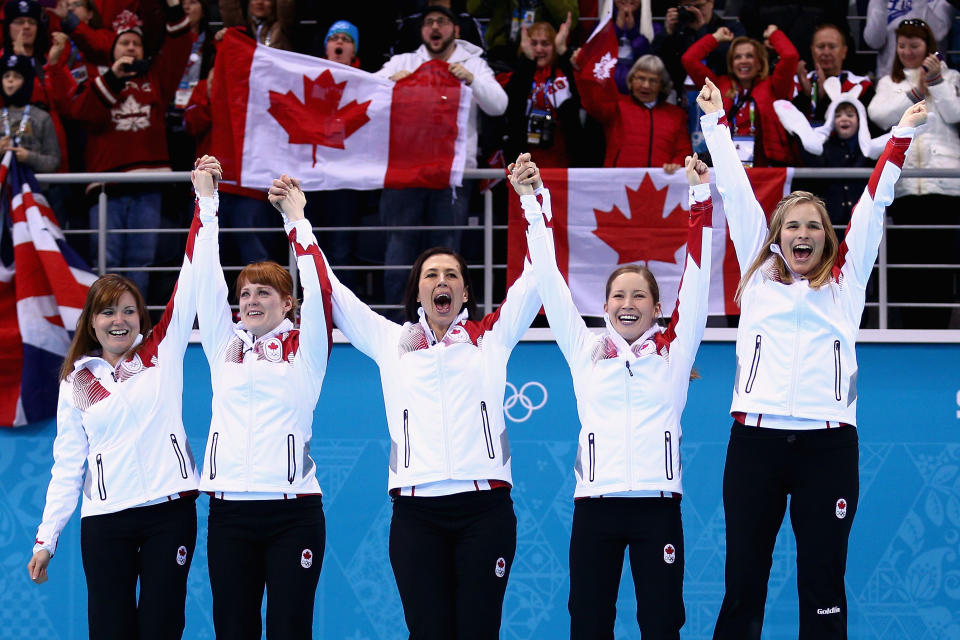 SOCHI, RUSSIA - FEBRUARY 20:  Gold medalists Jennifer Jones (R), Kaitlyn Lawes (2nd R), Jill Officer (C), Dawn McEwen (2nd L) and Kirsten Wall (L) of Canada celebrate during the flower ceremony for the Gold medal match between Sweden and Canada on day 13 of the Sochi 2014 Winter Olympics at Ice Cube Curling Center on February 20, 2014 in Sochi, Russia.  (Photo by Clive Mason/Getty Images)