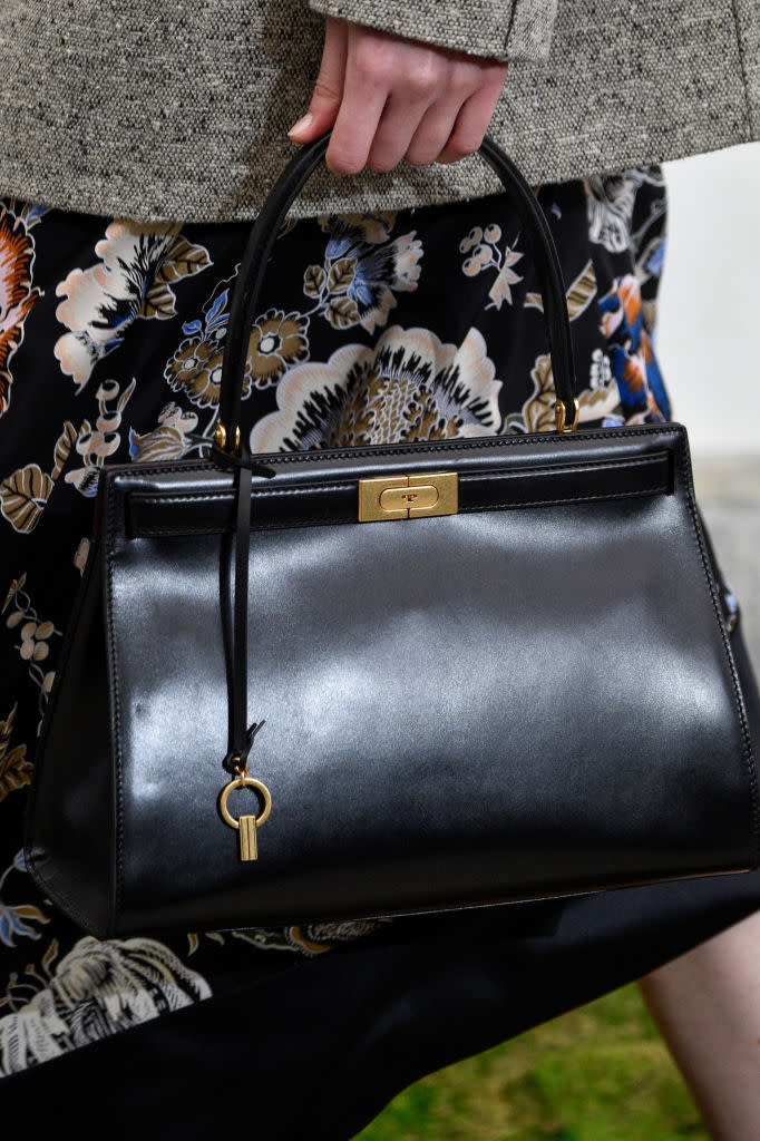 <p>A model carries a black top-handle bag from the Tory Burch FW18 show. (Photo: Getty Images) </p>