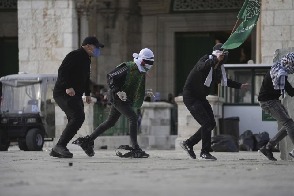 Palestinians clash with Israeli police at the Al Aqsa Mosque compound in Jerusalem's Old City, Friday, April 22, 2022. Israeli police and Palestinian youths clashed again at the major Jerusalem holy site sacred to Jews and Muslims on Friday despite a temporary halt to Jewish visits to the site, which are seen as a provocation by the Palestinians. (AP Photo/Mahmoud Illean)