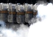 Riot police practise crowd control during a training session, with FBI agents, for troops providing security for the 2014 World Cup, in Rio de Janeiro May 15, 2014. The World Cup will be held in 12 cities in Brazil from June 12 till July 13. REUTERS/Sergio Moraes (BRAZIL - Tags: CIVIL UNREST SPORT SOCCER WORLD CUP)