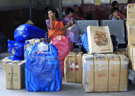 Stranded passengers wait inside a bus terminal in Pasay city, metro Manila December 14, 2015. REUTERS/Romeo Ranoco