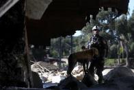 <p>A rescue team member gets some canine assistance during the rescue efforts following the mudslides that devastated Southern California.</p>