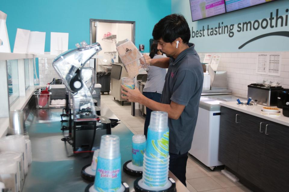 Planet Smoothie recently opened in Panama City. Pictured is Vinod Patel crafting a smoothie.