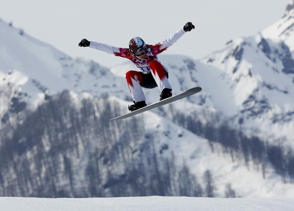 Canada's Dominique Maltais performs a jump during the women's snowboard cross qualification round at the 2014 Sochi Winter Olympic Games in Rosa Khutor February 16, 2014. REUTERS/Mike Blake (RUSSIA - Tags: SPORT OLYMPICS SPORT SNOWBOARDING)