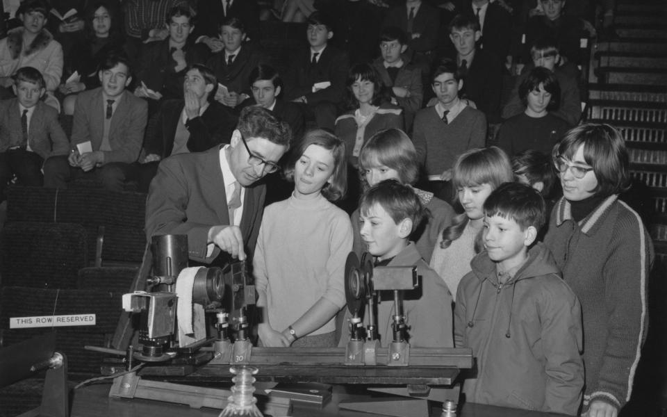 Hewish explains the use of a spectroscope to children at the first of his six Royal Institution Christmas Lectures in London in 1965, entitled The Exploration of the Universe - Keystone/Hulton Archive/Getty Images