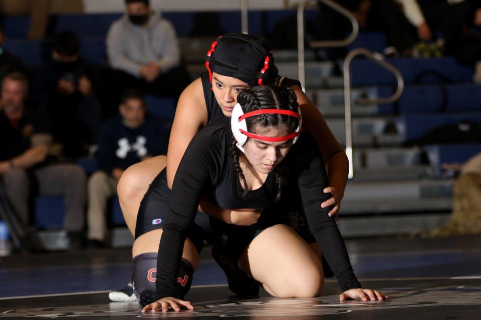 Stefany Morales (bottom), a student at International High School and a wrestler on the John F. Kennedy High School Wrestling Team, takes on Katlyn Juarez, of Passaic County Technical Institute, in Wayne.  Wednesday, January 19, 2022