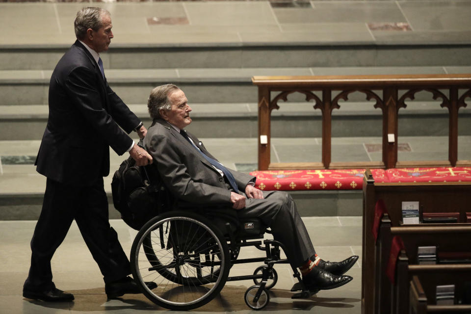 FILE - In this April 21, 2018 file photo, former Presidents George W. Bush, left, and George H.W. Bush arrive at St. Martin's Episcopal Church for a funeral service for former first lady Barbara Bush, in Houston. Presidents George H.W. Bush and George W. Bush were both conservatives, but during very different times. The elder Bush was a Republican who could carve an occasional moderate path without a crushing response from the right. His was an era of stepping back from the prospect of doomsday, with the collapse of the Soviet Union, and a far more limited threat emerging with Iraq’s invasion of Kuwait. But that was not at all like the Sept. 11 terrorist attacks that came early to his son.(AP Photo/David J. Phillip, File)