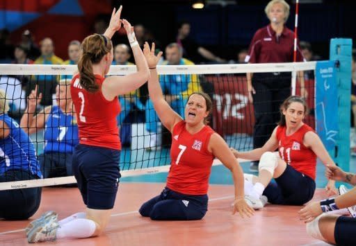 Great Britain's Martine Wright (2nd R) celebrates a point with team-mate Victoria Widdup (L) during their women's sitting volleyball match against Ukraine during the London 2012 Paralympic Games at the ExCel Centre in east London