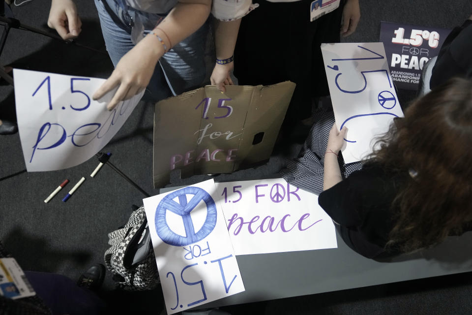 Activists hold signs for 1.5 degrees Celsius for Peace during a session at the COP27 U.N. Climate Summit, Thursday, Nov. 17, 2022, in Sharm el-Sheikh, Egypt. (AP Photo/Nariman El-Mofty)