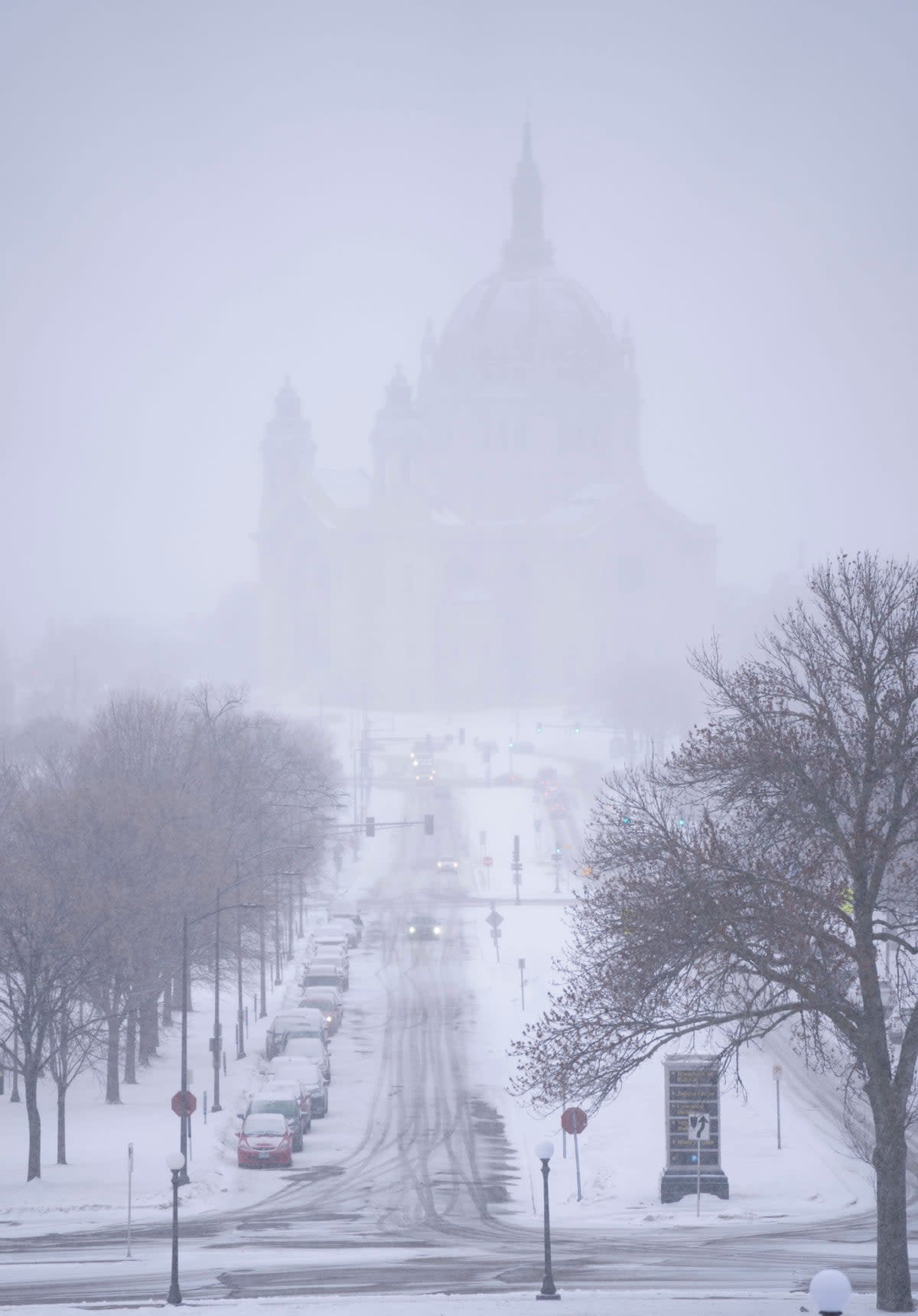Snow begins to fall around the Cathedral of Saint Paul, on Tuesday, Feb. 21, 2023, at the Minnesota State Capitol in St. Paul, Minn. A monster winter storm took aim at the Upper Midwest on Tuesday, threatening to bring blizzard conditions, bitterly cold temperatures and 2 feet of snow in a three-day onslaught that could affect more than 40 million Americans. (Alex Kormann/Star Tribune via AP) (AP)