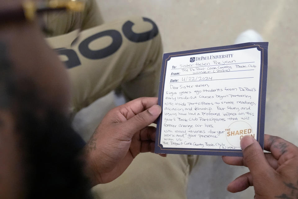 Stanley Allen, detainee in Division Of Correction 11, reads a note for Sister Helen Prejean during a book club at Department Of Corrections Division 11 in Chicago, Monday, April 22, 2024. DePaul students and detainees are currently reading Dead Man Walking and the author, anti death penalty advocate, Sister Helen Prejean attended to lead a discussion. (AP Photo/Nam Y. Huh)