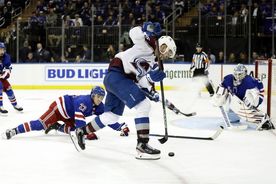 Colorado Avalanche right wing Mikko Rantanen controls the puck past New York Rangers defenseman Adam Fox (23) in the third period of an NHL hockey game Tuesday, Oct. 25, 2022, in New York. The Avalanche won 3-2 in a shootout. (AP Photo/Adam Hunger)