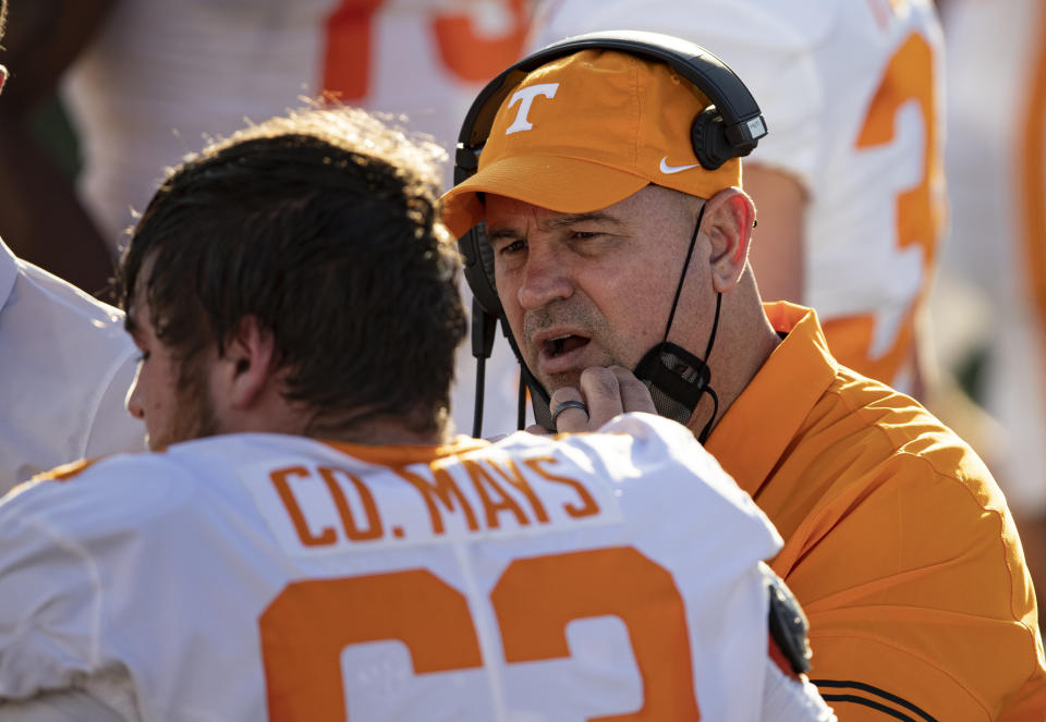 Tennessee head coach Jeremy Pruitt, right, talks with offensive lineman Cooper Mays (63) during the first half of an NCAA college football game against Vanderbilt, Saturday, Dec. 12, 2020, in Nashville, Tenn. (AP Photo/Wade Payne)