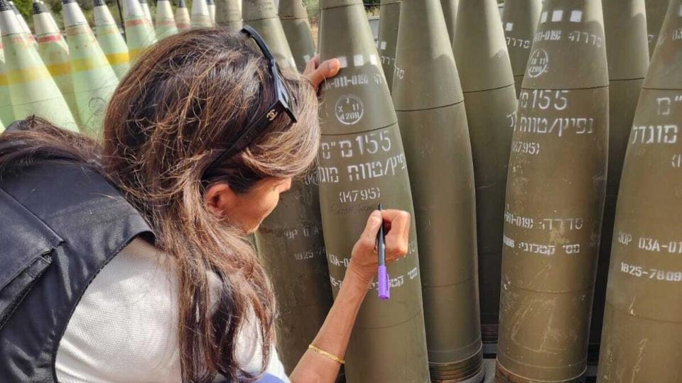 PHOTO: Former U.S. presidential candidate Nikki Haley signs artillery shells near the northern border of Israel on Tuesday, May 28, 2024. (Courtesy Nikki Haley)