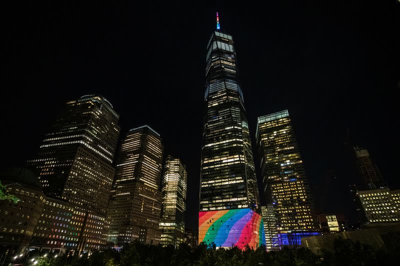 The spire of One World Trade Center is lit in rainbow colors in Manhattan