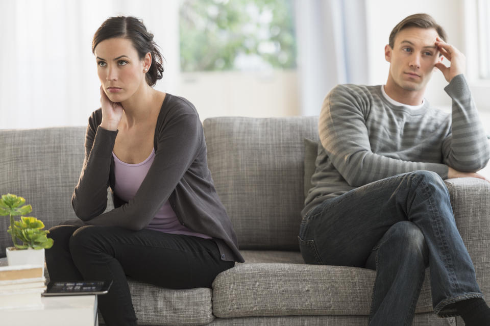 Couple looking angry on sofa (Getty Images)