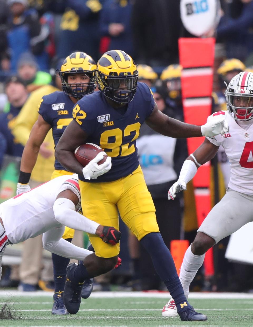 Michigan Wolverines right end Nick Eubanks is tackled by Ohio State Buckeyes cornerback Jeff Okudah during the first half Saturday, Nov. 30, 2019 at Michigan Stadium.