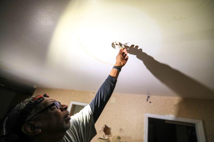 Jim Gaillard inspects some electrical wires Thursday, Dec. 16, 2021, at 3504 N. 61st, Milwaukee. Ebony Cox / Milwaukee Journal Sentinel