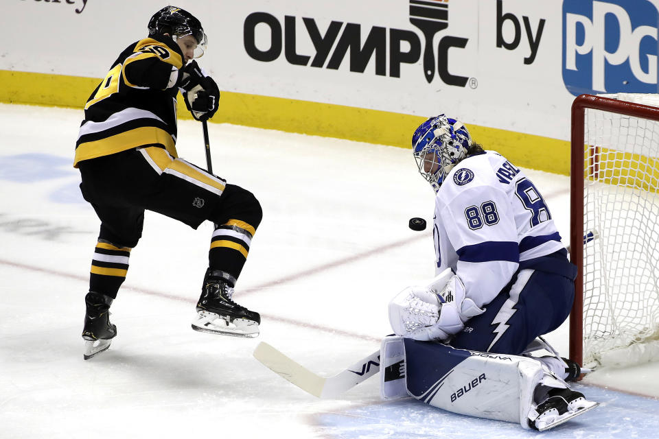 Tampa Bay Lightning goaltender Andrei Vasilevskiy (88) stops a shot by Pittsburgh Penguins' Jared McCann (19) during the first period of an NHL hockey game in Pittsburgh, Tuesday, Feb. 11, 2020. (AP Photo/Gene J. Puskar)