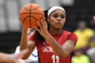 Sacred Heart Academy guard ZaKiyah Johnson looks to pass during a high school basketball game against Mercy Academy in Louisville, Ky., Sunday, Feb. 11, 2024. Recruitment letters have overwhelmed one long shoe box, along with a backpack set aside for the frontrunners. ZaKiyah Johnson will eventually get around to reading them, her mother believes, though it could be a while before the highly prized basketball recruit responds to those piquing her interest. (AP Photo/Timothy D. Easley)