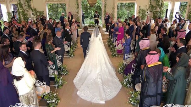 PHOTO: Rajwa Al Said walks with Jordan's Prince Hashem bin Abdullah, towards Jordan's Crown Prince Hussein and Jordan's King Abdullah II, on the day of her royal wedding ceremony to Prince Hussein, in Amman, Jordan, June 1, 2023, in an image from a video. (Royal Hashemite Court via Reuters)