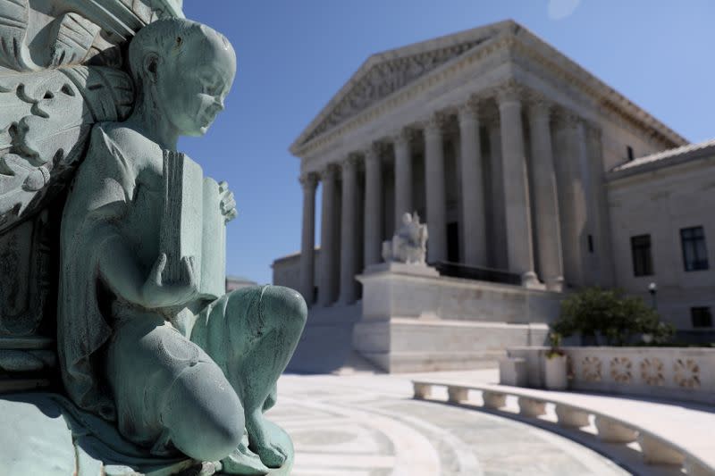 FILE PHOTO: A cherub figure with a book, symbolizing learning, is seen in a general view of the U.S. Supreme Court building in Washington