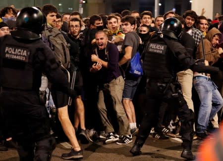 Protesters form barricades as they demonstrate at the airport, after a verdict in a trial over a banned independence referendum, in Barcelona