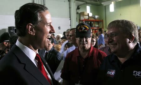 Republican presidential candidate and former U.S. Senator Rick Santorum (L) speaks to a member of the crowd after formally declaring his candidacy for the 2016 Republican presidential nomination during an announcement event in Cabot, Pennsylvania, May 27, 2015. REUTERS/Aaron Josefczyk
