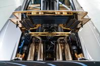 <p>The F1's exhaust setup looks fine from the outside, but springs to life once you peak under the rear bonnet. Vast swaths of the engine bay are covered in gold leaf to reduce heat soak, framing the exhaust in a gilded bed. </p>