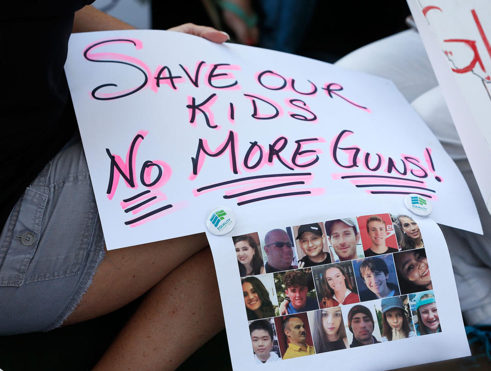 <p>Protesters hold signs at a gun control at the Broward County Federal Courthouse in Fort Lauderdale, Fla., on Feb. 17, 2018. (Photo: Rhona Wise/AFP/Getty Images) </p>