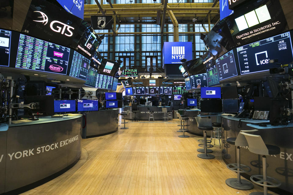 FILE - This photo provided by the New York Stock Exchange shows the unoccupied NYSE trading floor, closed temporarily for the first time in 228 years as a result of coronavirus concerns, Tuesday March 24, 2020. Global stocks and U.S. futures declined Thursday after the U.S. Senate approved a proposed $2.2 trillion virus aid package following a delay over its details and sent the measure to the House of Representatives. (Kearney Ferguson/NYSE via AP, File)